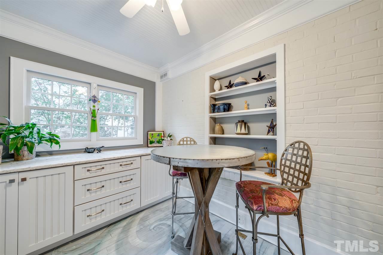 2607 Van Dyke Avenue Raleigh, NC 27607 - Photo 9 of 26 a kitchen with a table chairs and cabinets
