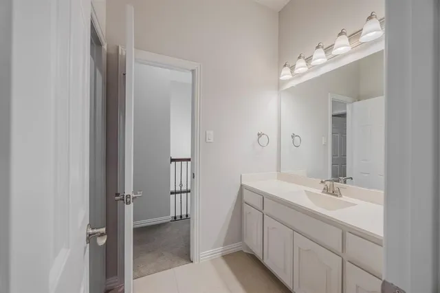 a bath tub sitting next to a white sink and a shower