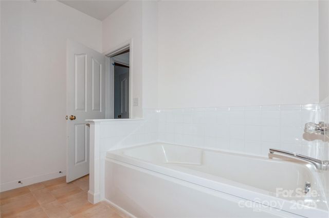 a white bath tub sitting next to a white sink