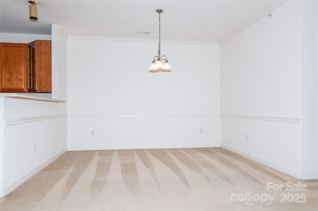 a view of a room with wooden floor and windows