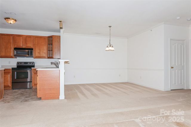 wooden floor in an empty room with a kitchen