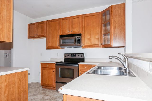 a kitchen with a sink a stove and cabinets