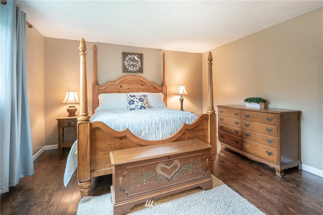 6820 Goodwin Road Everson, WA 98247 - Photo 11 of 34 a bedroom with a bed and wooden floor