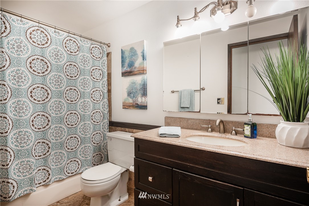 6820 Goodwin Road Everson, WA 98247 - Photo 16 of 34 a bathroom with a granite countertop toilet sink and mirror