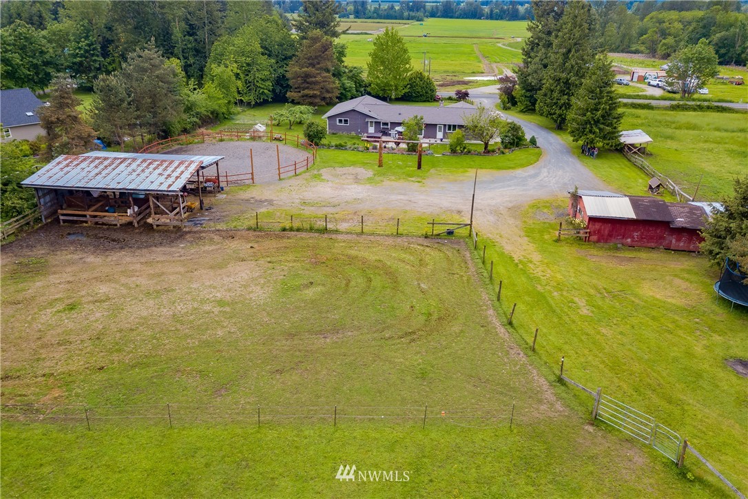 6820 Goodwin Road Everson, WA 98247 - Photo 25 of 34 a view of a swimming pool with lawn chairs under an umbrella