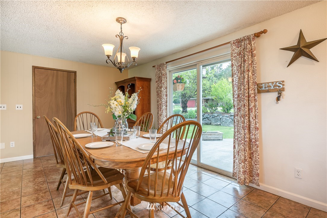 6820 Goodwin Road Everson, WA 98247 - Photo 7 of 34 a dining room with furniture a chandelier and window