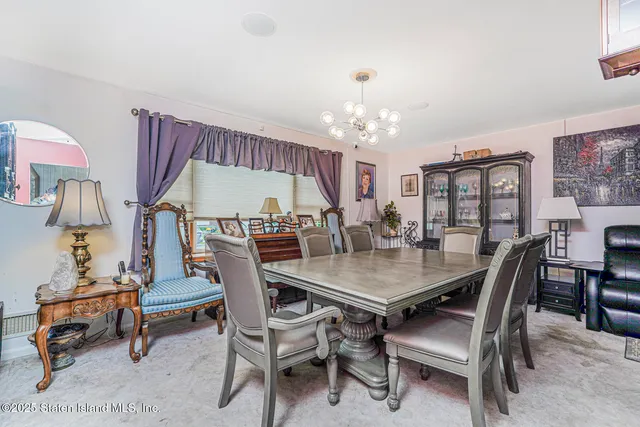 a view of a dining room with furniture and chandelier