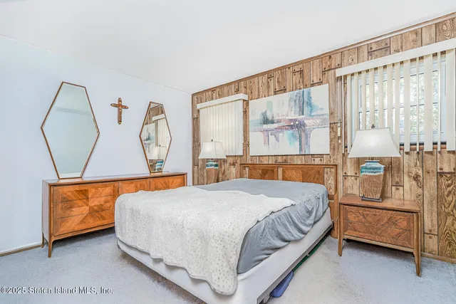 a bedroom with a bed a couch and dresser