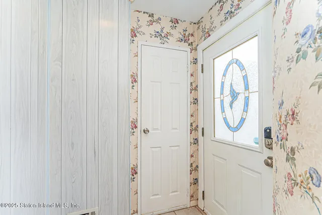 a bathroom with a shower and a window curtain