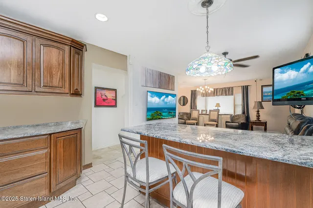 a dining table with chairs and chandelier