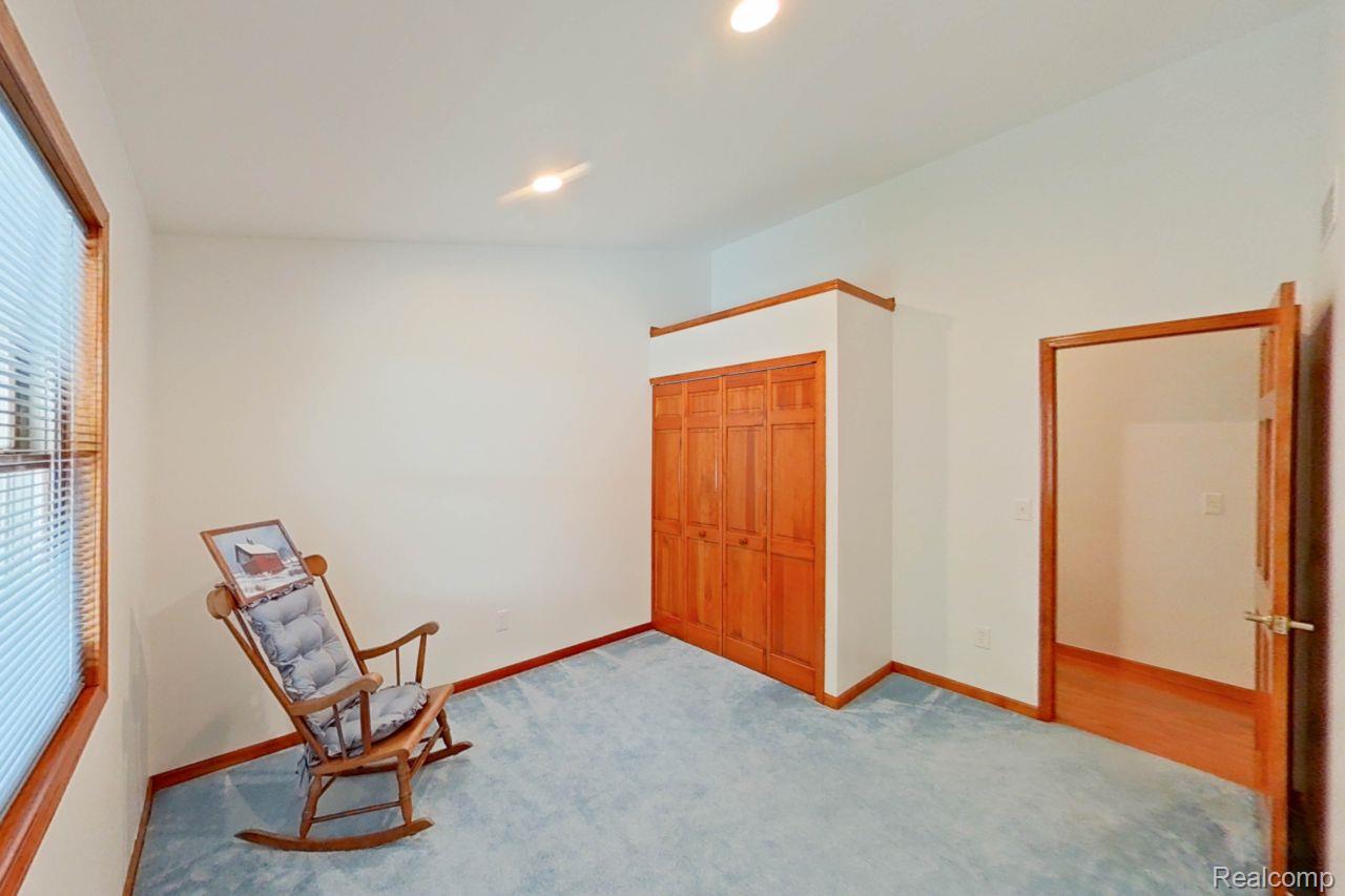 10201 Washburn Road Goodrich, MI 48438 - Photo 53 of 85 Room featuring light blue carpeting, white walls, and wood trim details