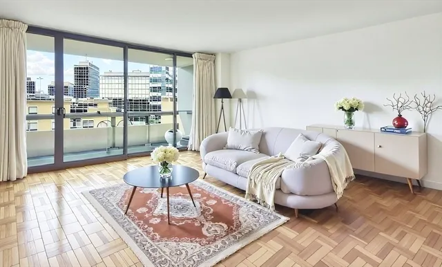 a living room with furniture and a floor to ceiling window