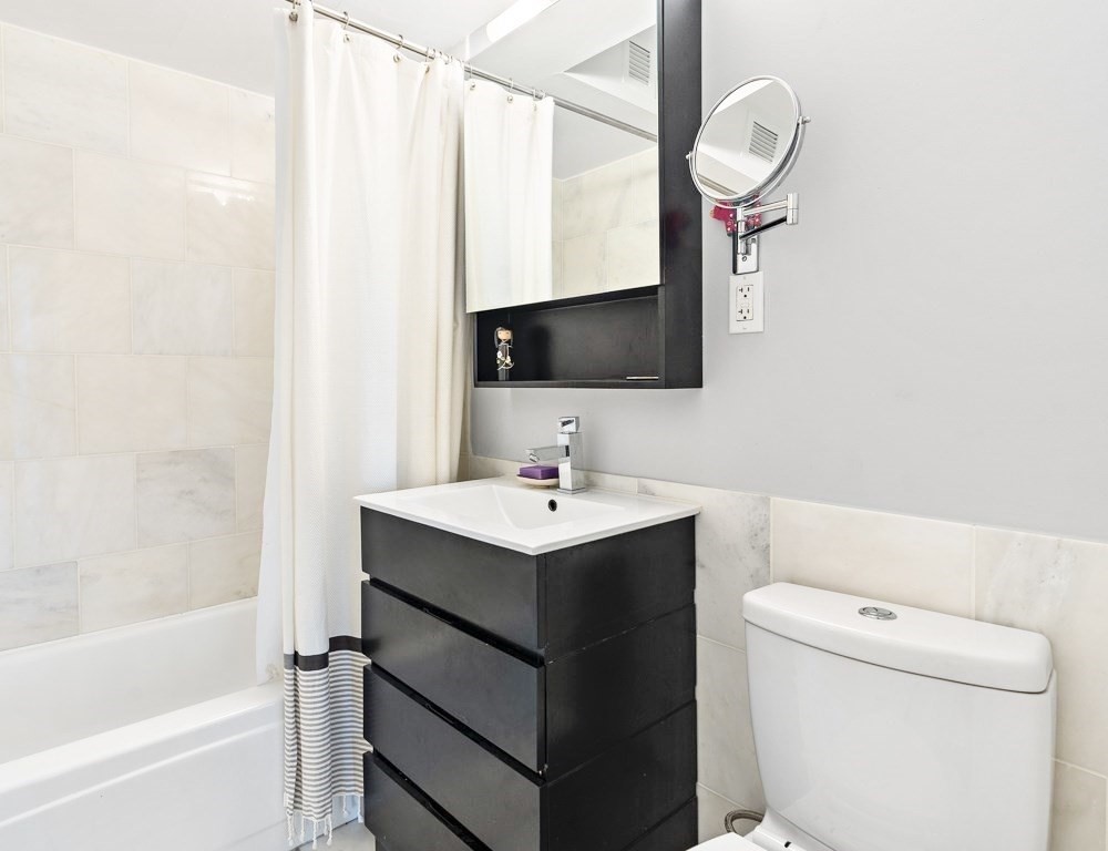 566 Commonwealth Avenue, Unit 706 Boston, MA 02215 - Photo 3 of 9 a bathroom with a sink toilet and shower
