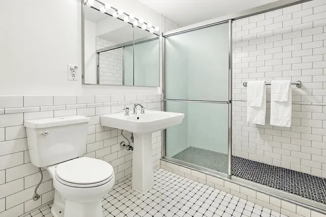 a bathroom with a sink toilet and shower