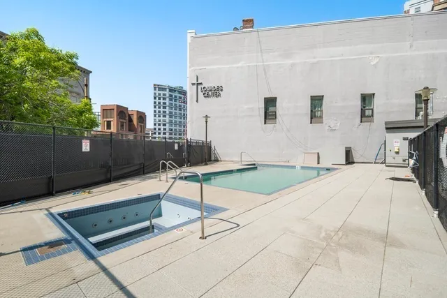 a building outdoor space with seating area and trees