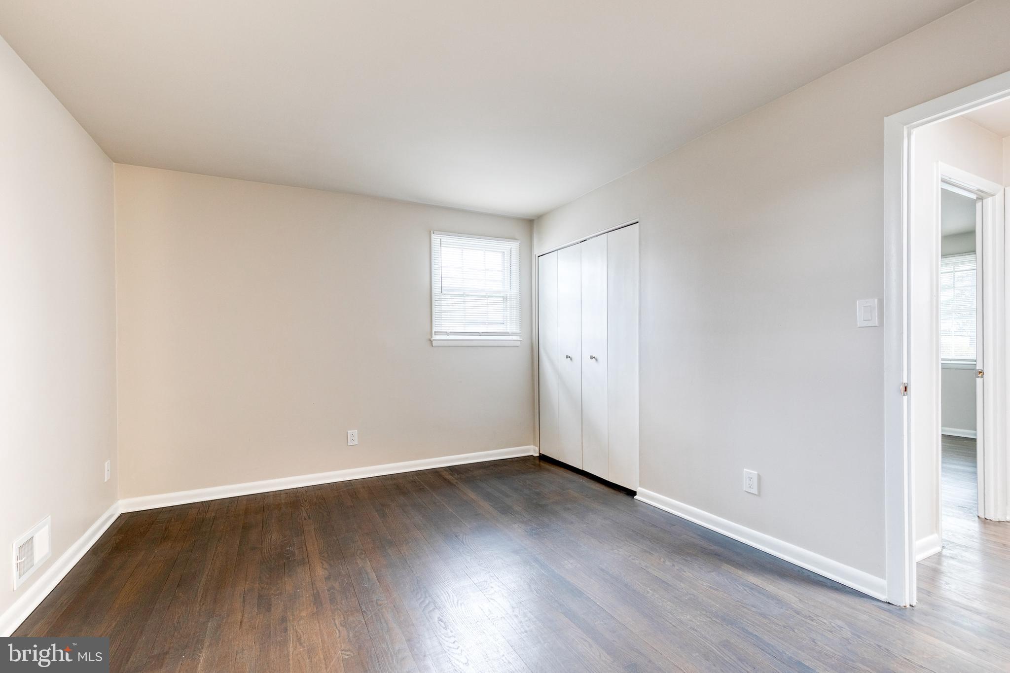 3719 Brenbrook Drive Randallstown, MD 21133 - Photo 12 of 24 an empty room with wooden floor and windows