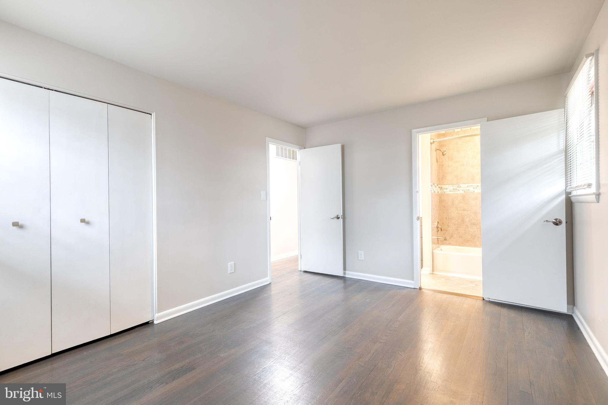3719 Brenbrook Drive Randallstown, MD 21133 - Photo 13 of 24 an empty room with wooden floor and a window