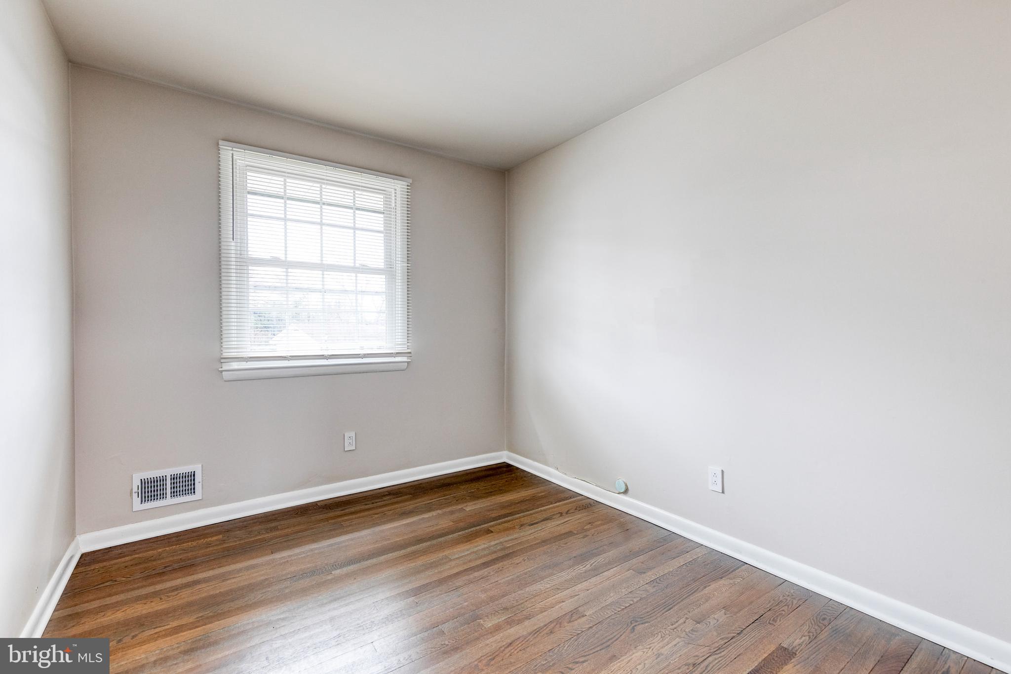 3719 Brenbrook Drive Randallstown, MD 21133 - Photo 15 of 24 an empty room with wooden floor and windows