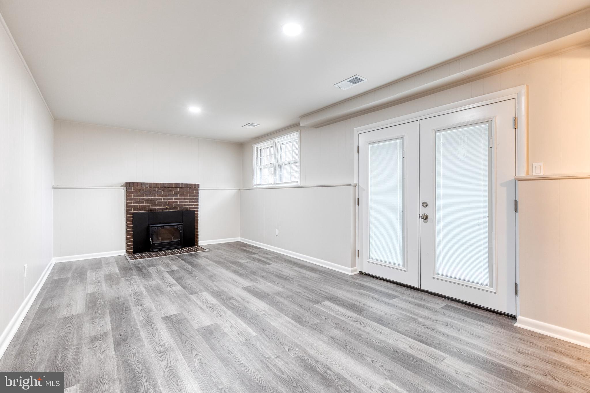 3719 Brenbrook Drive Randallstown, MD 21133 - Photo 17 of 24 a view of empty room with wooden floor and fireplace
