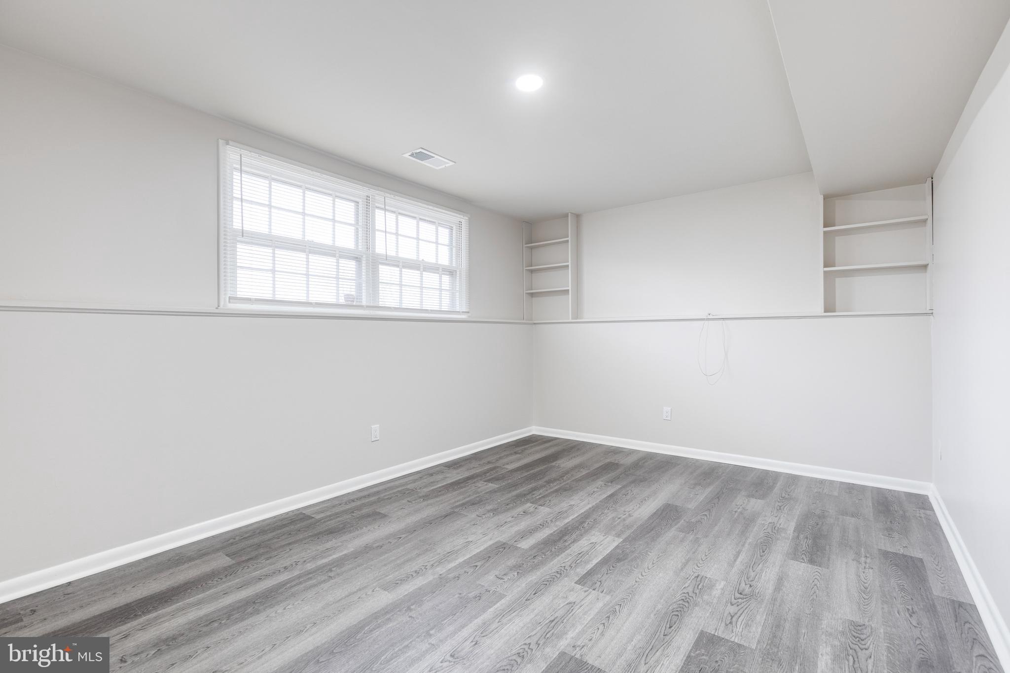 3719 Brenbrook Drive Randallstown, MD 21133 - Photo 18 of 24 an empty room with wooden floor and windows