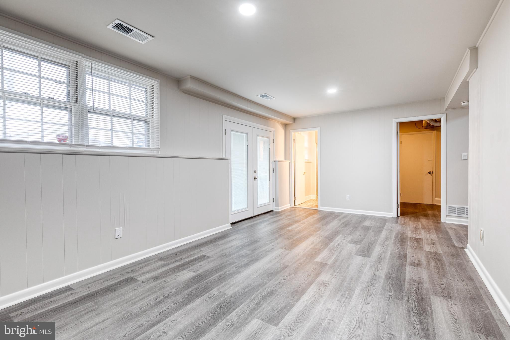 3719 Brenbrook Drive Randallstown, MD 21133 - Photo 19 of 24 wooden floor in an empty room with a window
