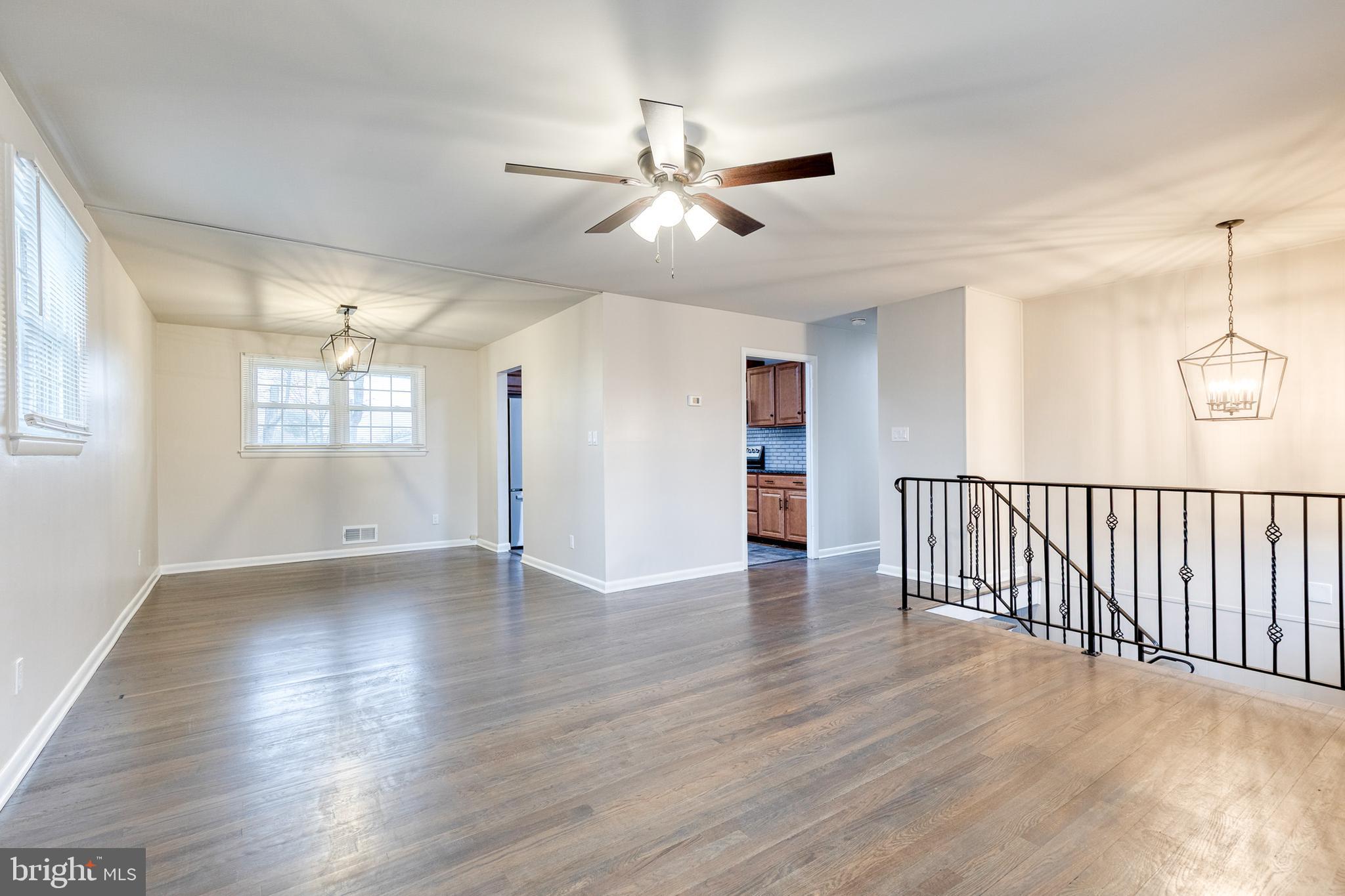 3719 Brenbrook Drive Randallstown, MD 21133 - Photo 4 of 24 a view of an empty room with wooden floor and a window
