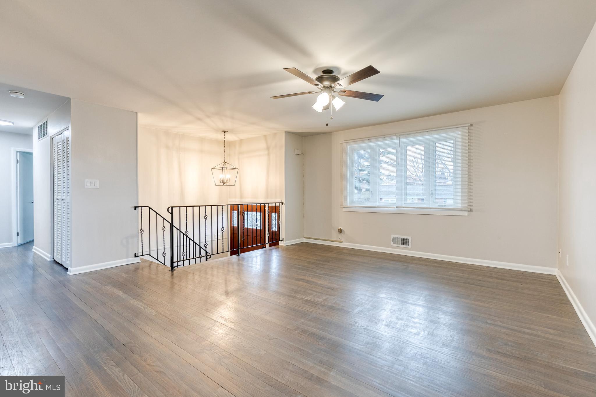 3719 Brenbrook Drive Randallstown, MD 21133 - Photo 6 of 24 a view of an empty room with wooden floor and a window