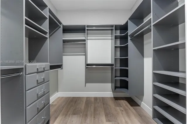 a view of walk in closet with empty racks