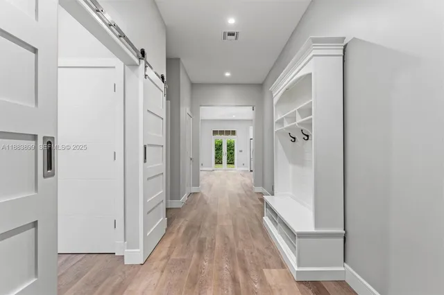 a view of hallway with wooden floor
