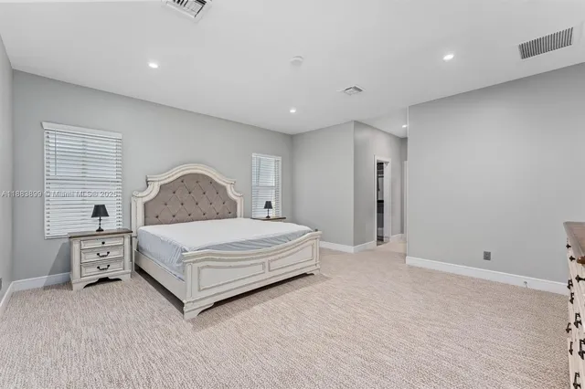 a bedroom with a large bed and a table