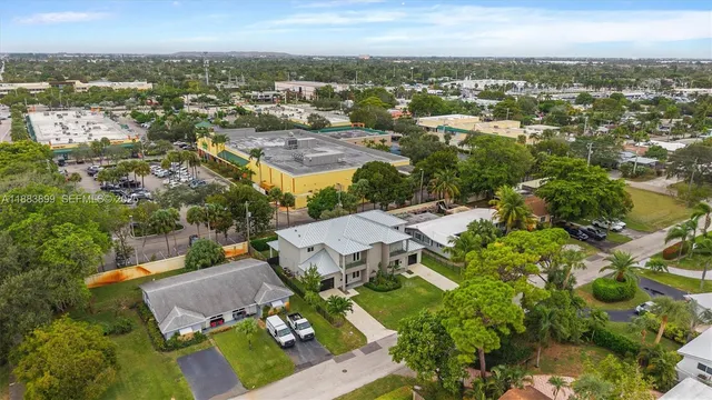 an aerial view of residential building with green space