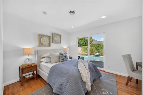 a bedroom with a bed and a chair