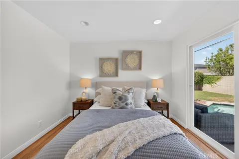 a bedroom with a bed and a painting on the wall