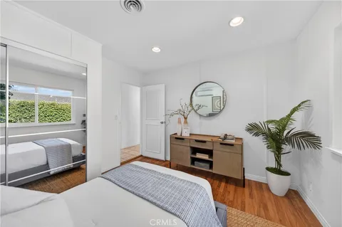 a bedroom with furniture a chandelier and a window