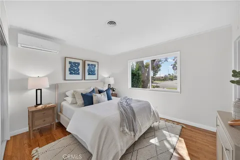 a bed room with a bed and a painting on the wall
