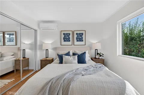 a bedroom with a bed and a large window