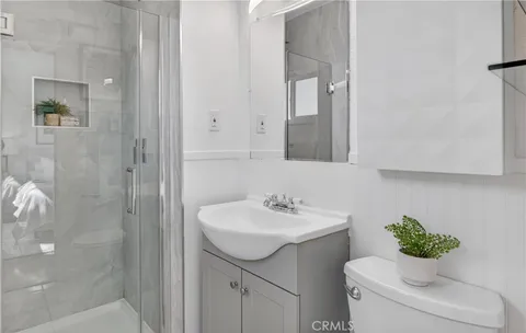 a bathroom with a sink toilet and a mirror