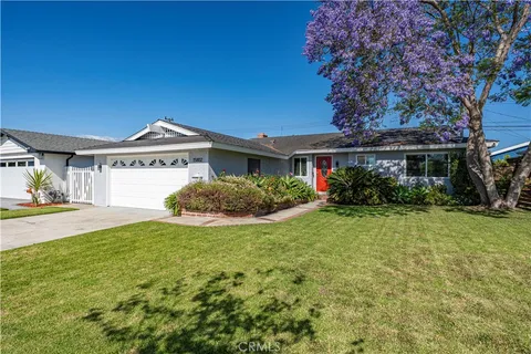 a view of a house with a big yard and potted plants