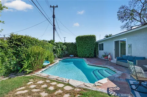 an aerial view of a house with yard swimming pool and outdoor seating