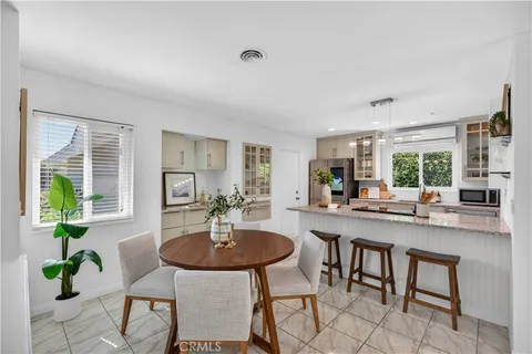 a kitchen with a table and chairs in it