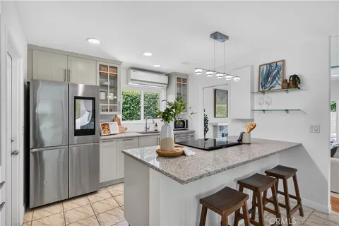 a kitchen with granite countertop a refrigerator and a sink
