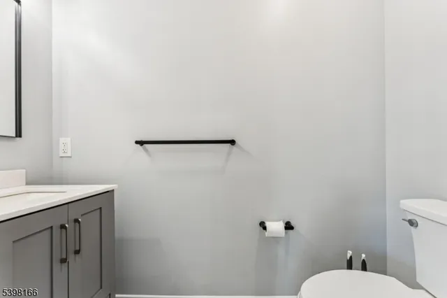 a bathroom with a toilet sink and vanity