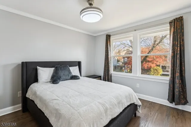 a large bed sitting in a bedroom next to a window
