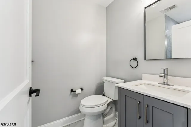 a bathroom with a sink toilet and a mirror