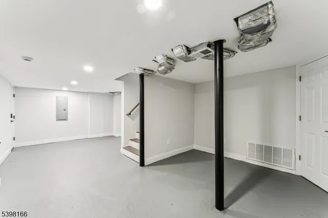 a bathroom with a toilet sink vanity and shower