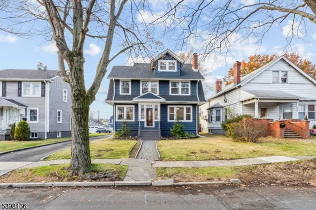 a picture of a bench in front of a white house