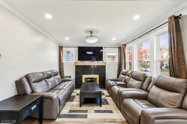 a living room with furniture a large window and a fireplace