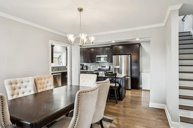 a living room with kitchen island furniture and a chandelier