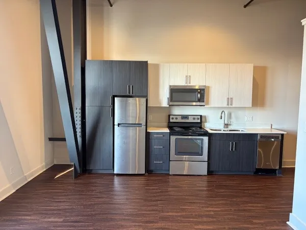 a kitchen with a refrigerator and a sink