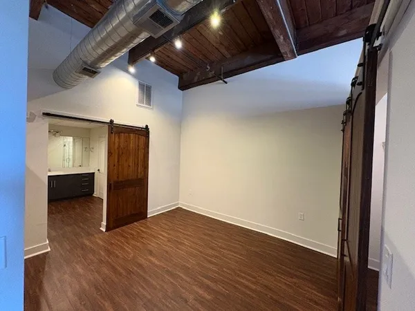a view of hallway with wooden floor